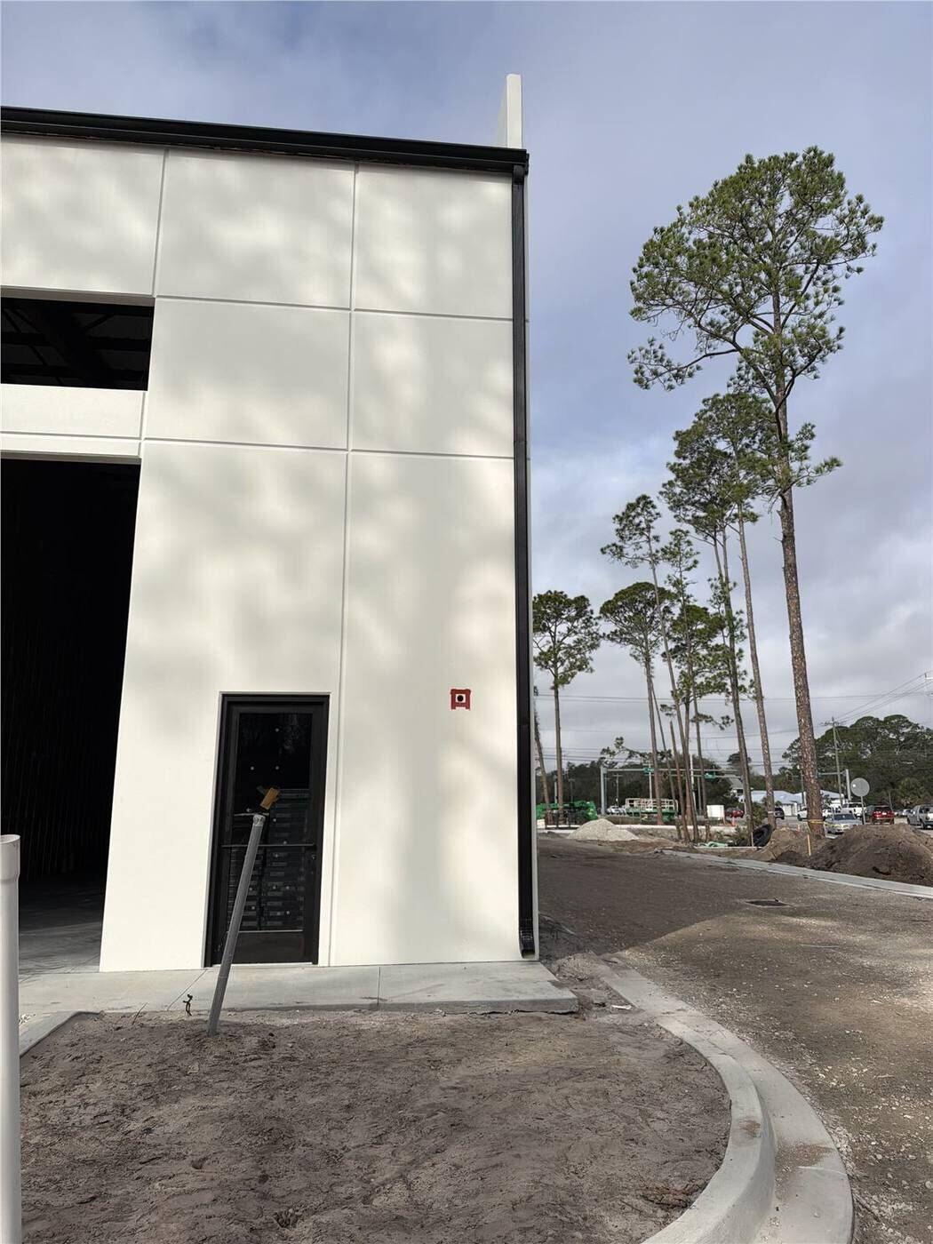 Finished black commercial gutter and downspout on a tall building