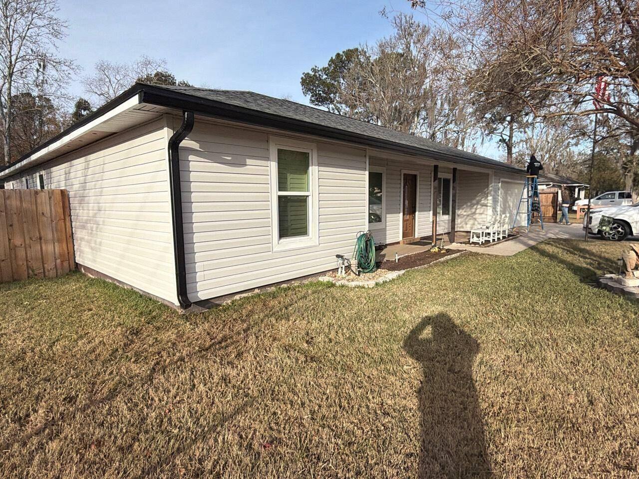 Black seamless gutters installed on a single-story North Florida home